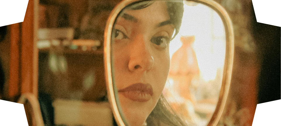 Portrait of a woman in soft light, framed in a keyhole cutout